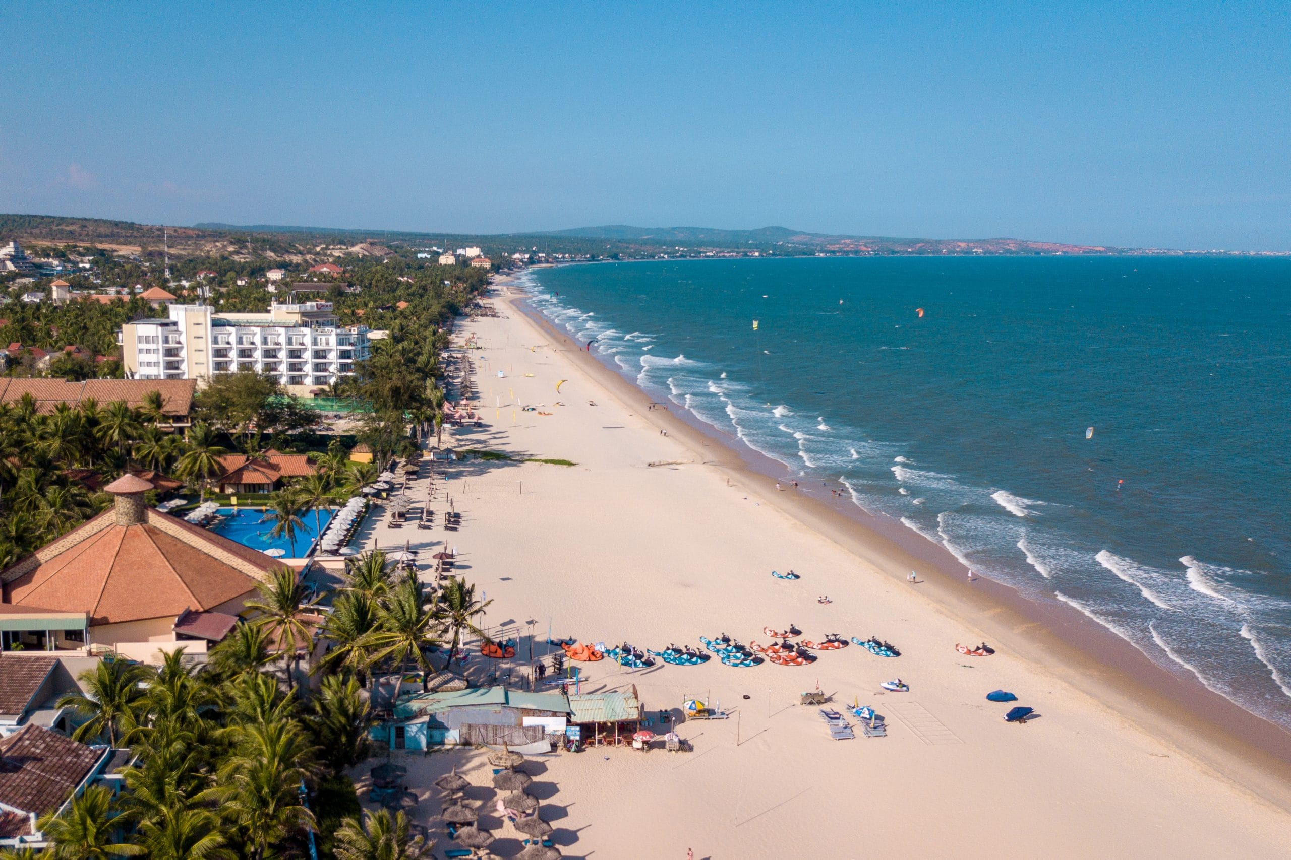 Drone view of C2SKY beach with kite and wing foil setup area, showcasing the kitesurfing and wing foiling conditions in Mui Ne, Vietnam.