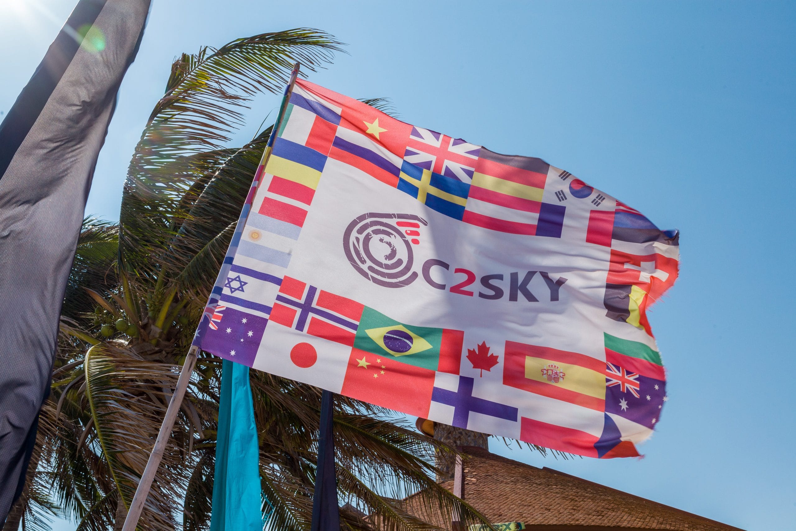 C2SKY international flag display welcoming visitors from all countries, offering airport transfers from Ho Chi Minh City to Mui Ne