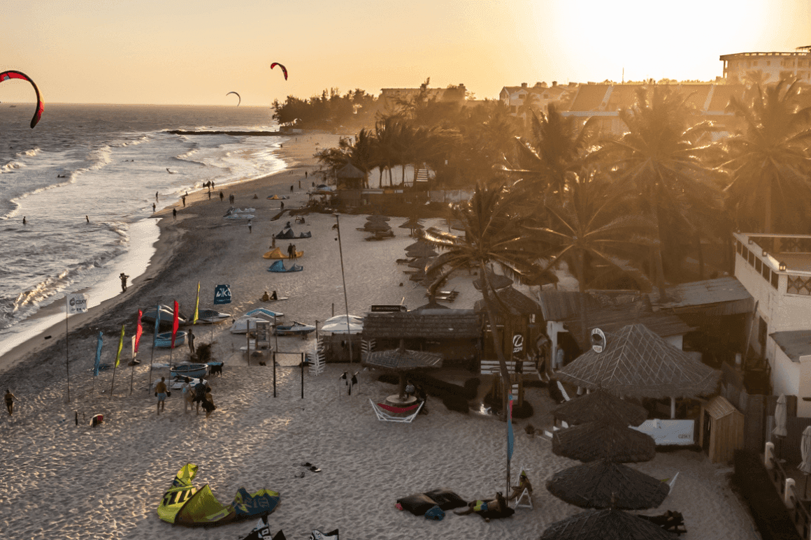 Sunset at the C2SKY beach location with kites in the air, showcasing the vibrant atmosphere of the team at work. Wing Foiling Lessons Vietnam Mui Ne